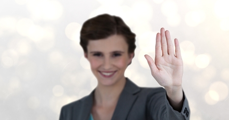 Digital composite of Smiling businesswoman showing stop gestureの写真素材