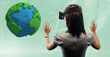 Digital composite of Rear view of businesswoman looking at low poly earth on VR glasses