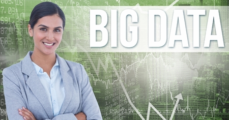 Digital composite of Smiling businesswoman with arms crossed by big data text on screenの写真素材