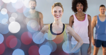 Digital composite of Happy fit woman with friends in gym