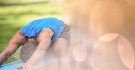 Digital composite of Man performing yoga in parkの写真素材