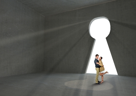 Digital composite of Couple embracing at keyhole shape doorwayの写真素材