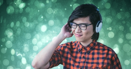Digital composite of Smiling man enjoying music on headphones