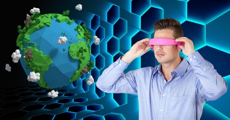 Digital composite of Businessman wearing VR headphones by low poly earth