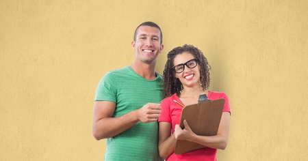 Digital composite of Portrait of smiling business people standing against yellow background