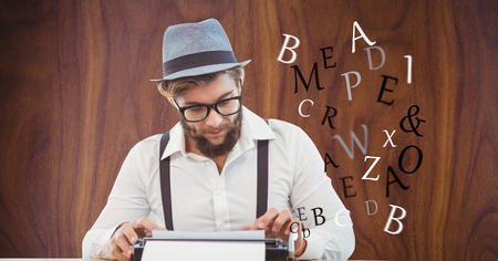 Digital composite of Hippie businessman using type writer against wall