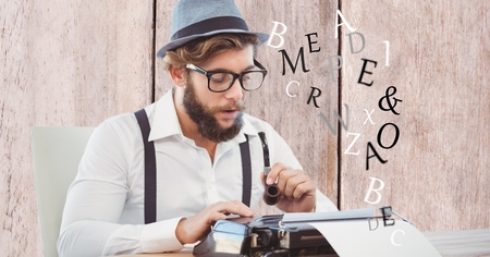 Digital composite of Hipster holding smoking pipe while using typewriterの写真素材