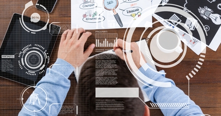 Digital composite of Businessman writing notes with overlayの写真素材