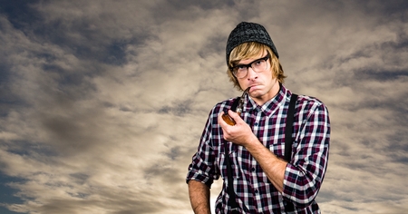 Digital composite of Confident hipster smoking pipe against skyの写真素材