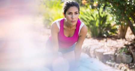 Digital composite of Female jogger looking away in parkの写真素材