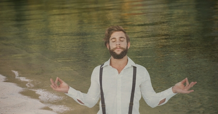Digital composite of Double exposure of hipster meditating at shoreの写真素材