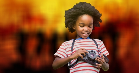 Digital composite of Boy using camera over bokehの写真素材