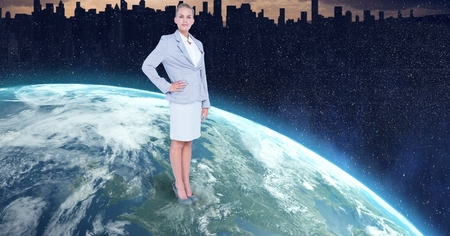 Digital composite of Businesswoman standing on globeの写真素材