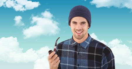 Digital composite of Smiling hipster holding smoking pipe against skyの写真素材