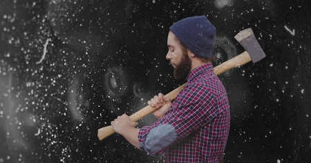 Digital composite of Side view of hipster holding ax