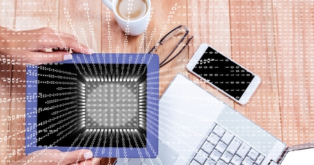Digital composite of Businesswoman holding digital tablet at desk with overlay