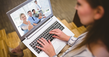 Digital composite of Woman video conferencing with colleagues on laptop