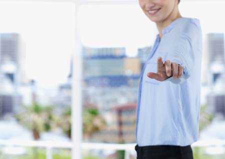 Digital composite of Midsection of businesswoman touching imaginary screenの写真素材