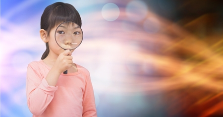Digital composite of Portrait of girl looking through magnifying glass over bokehの写真素材