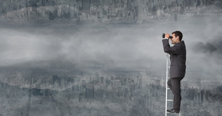 Digital composite of Businessman using binoculars on ladder against upside down city with cloudsの写真素材