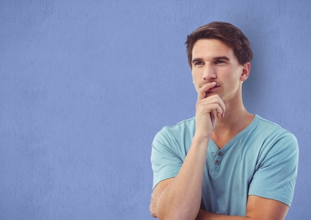 Digital composite of Thoughtful male hipster against blue backgroundの写真素材