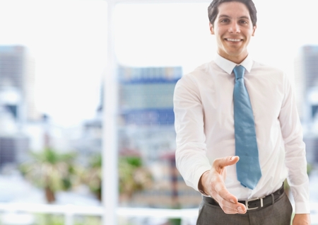 Digital composite of Portrait of confident businessman offering handshakeの写真素材