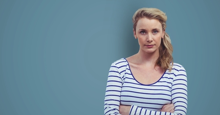 Digital composite of Confident female hipster standing arms crossed against blue background