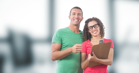 Digital composite of Portrait of smiling business people with clipboardの写真素材