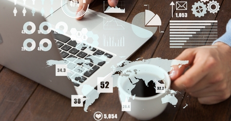 Digital composite of Digital image of cropped hands working on laptop with various symbols while...