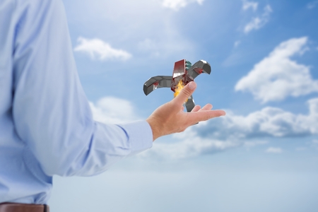 Digital composite of rocket on hand
