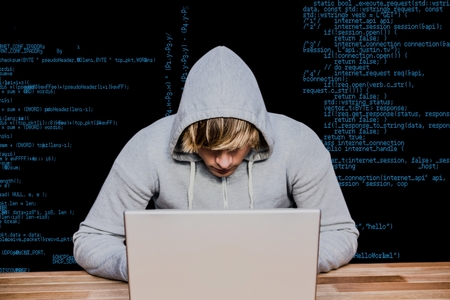 Digital composite of hacker using his laptop against order linesの写真素材