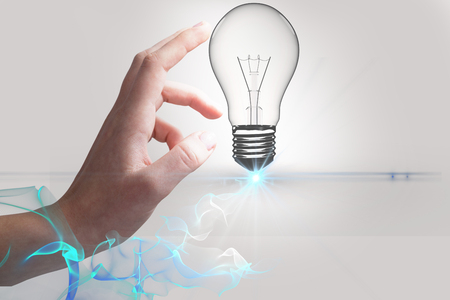 Digital composite of bulb on handsの写真素材