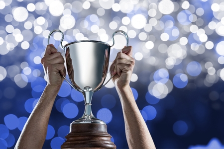 Digital composite of holding trophyの写真素材