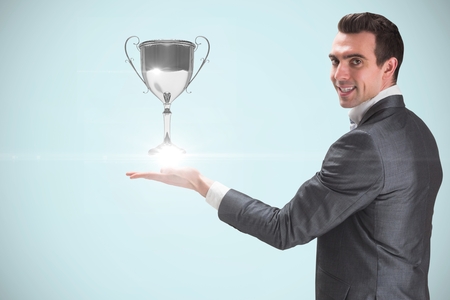 Digital composite of holding trophyの写真素材