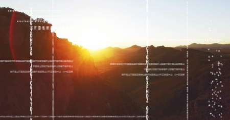 Digital composite of White code against mountain and sunset