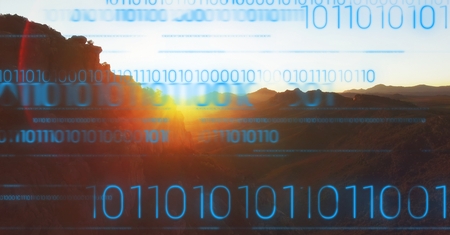 Digital composite of Blue binary code against mountain and sunset
