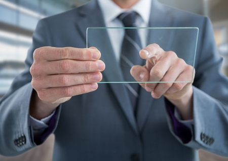 Digital composite of Businessman holding glass tabletの写真素材