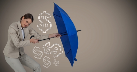Digital composite of Business woman with umbrella gathering money graphics against brown backgroundの写真素材