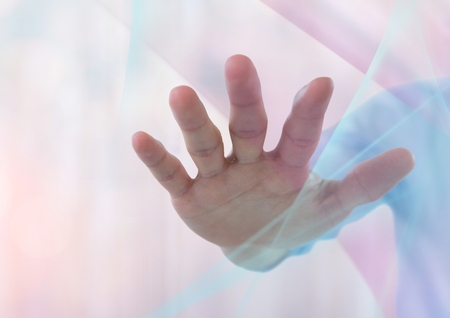 Digital composite of Hand reaching spread out with sparkling light bokeh background