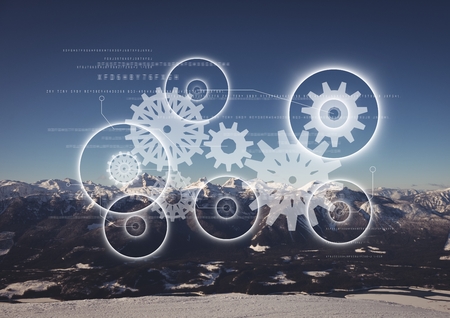 Digital composite of White gear graphic against mountains