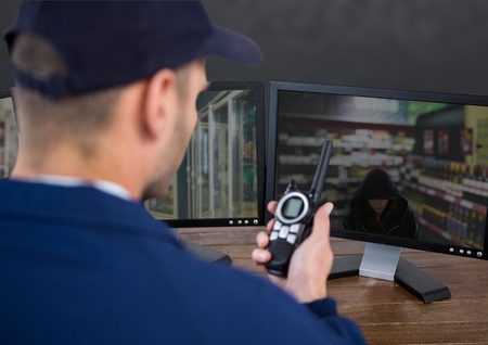 Digital composite of security guard of the supermarket warning the police of the stealの写真素材