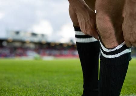 Digital composite of soccer player putting good the shocksの写真素材