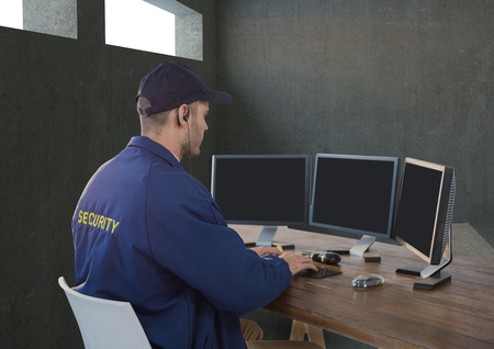Digital composite of security guard tin his desk with his technology.