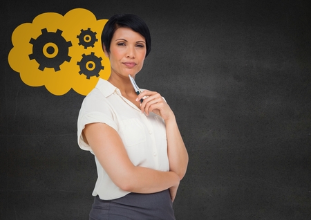 Digital composite of Business woman thinking against grey wall and yellow cloud with gear graphicの写真素材