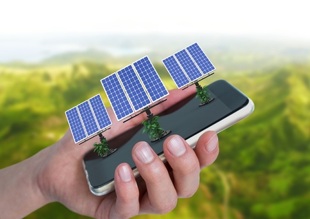 Digital composite of solar panels on hand with mountains behind