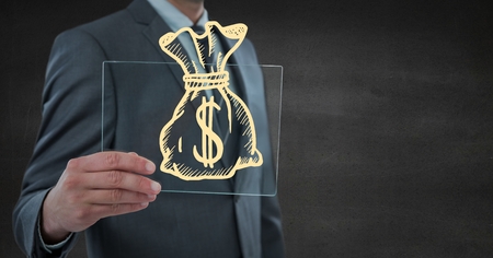 Digital composite of Business man mid section with glass device and yellow money doodle against grey wallの写真素材