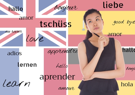 Digital composite of main language flags background with young woman thinking and word in different languagesの写真素材