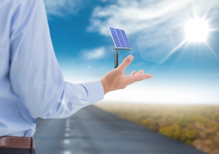 Digital composite of solar panel on businessman hand in the roadの写真素材