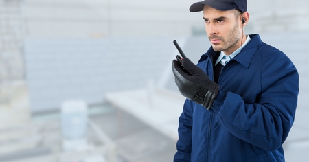 Digital composite of Security man  on bright background of  rooftop building siteの写真素材