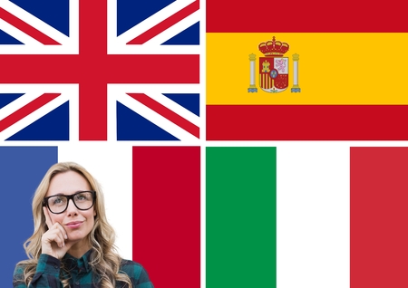 Digital composite of main language flags around young woman thinkingの写真素材